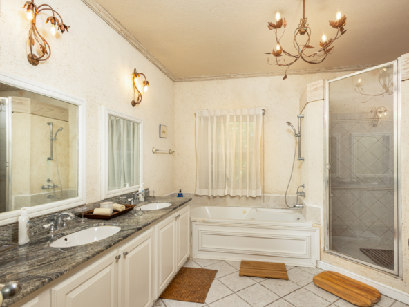 Serene master bedroom in Mon Caprice, Sandy Lane, with elegant furnishings and tropical views in Barbados.