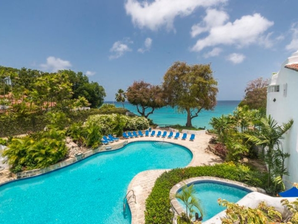 Outdoor pool and sea views at three bedroom beachfront villa in Barbados, Merlin Bay.