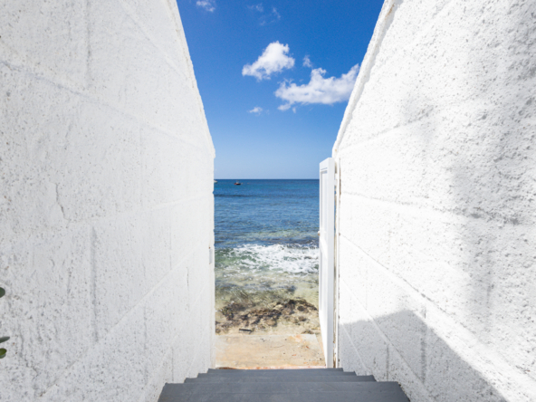 Barbados luxury beachfront villa with private beach access showing stairs down to the Caribbean Sea