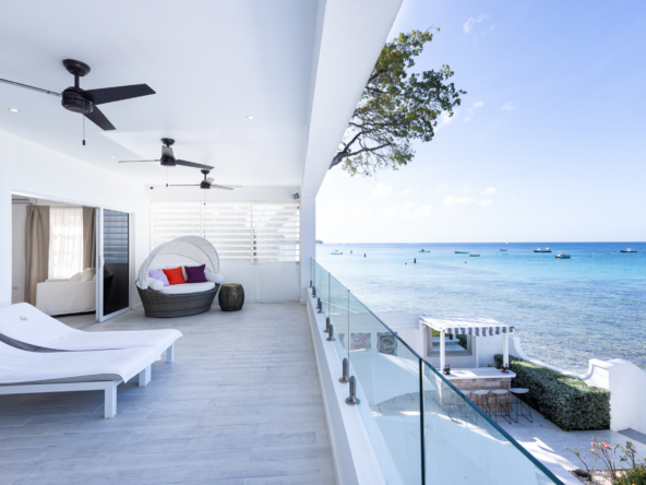 Barbados luxury modern beachfront villa view from master bedroom extensive terrace, to the gardens and Caribbean Sea views beyond
