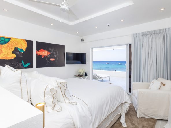 Barbados luxury modern beachfront villa guest suite with spacious balcony and Caribbean Sea views