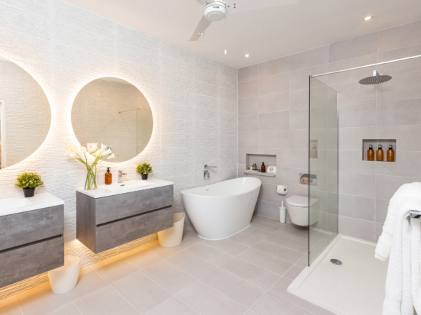 Barbados luxury modern beachfront villa guest suite with bathroom features two sinks bath and shower