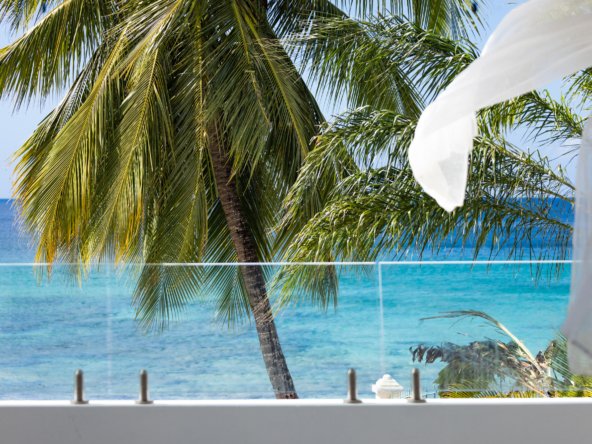 Barbados luxury modern beachfront villa guest suite with spacious balcony and Caribbean Sea views
