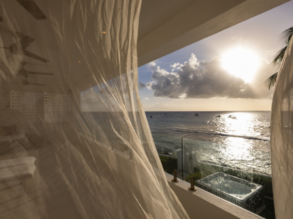 Barbados luxury modern beachfront villa balcony with Caribbean Sea sunset views