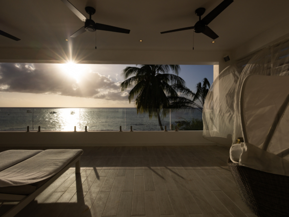 Barbados luxury modern beachfront villa balcony with Caribbean Sea sunset views