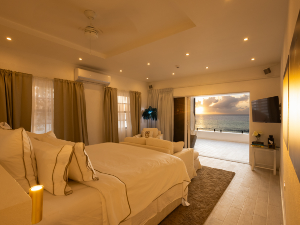 Barbados luxury modern beachfront villa master suite with Caribbean Sea sunset views