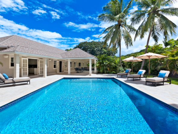 This stunning Barbados real estate gem offers exclusive golfing access, making it a dream home for golf enthusiasts. The property features a luxurious swimming pool with a spacious pool deck surrounded by lush gardens and swaying coconut trees.