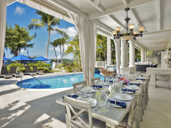 Outdoor dining and pool at luxury Paynes Bay villa, New Mansion