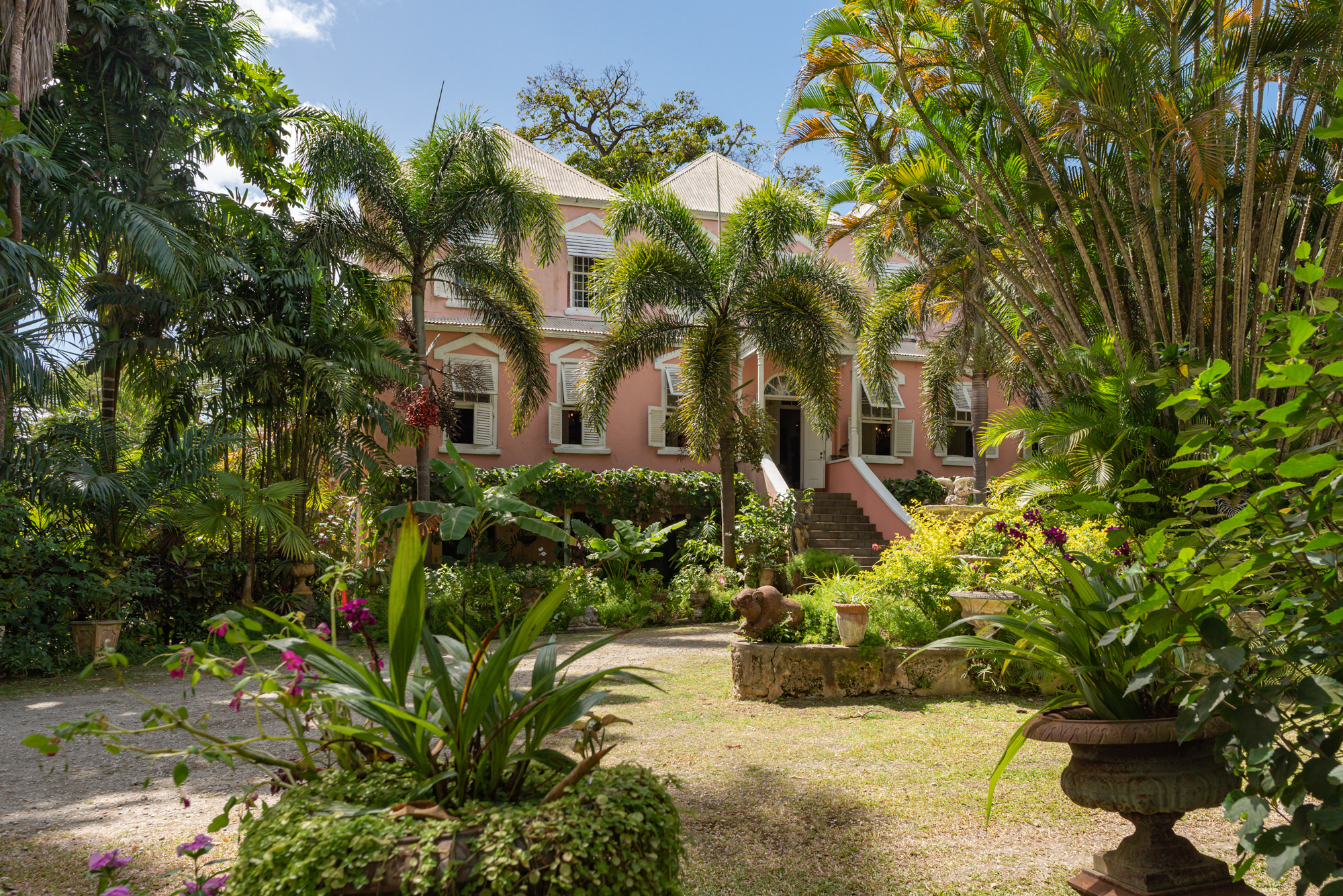 Tropical garden and exterior of a pink grand house of Barbados property market investment opportunity, Lancaster Great House.