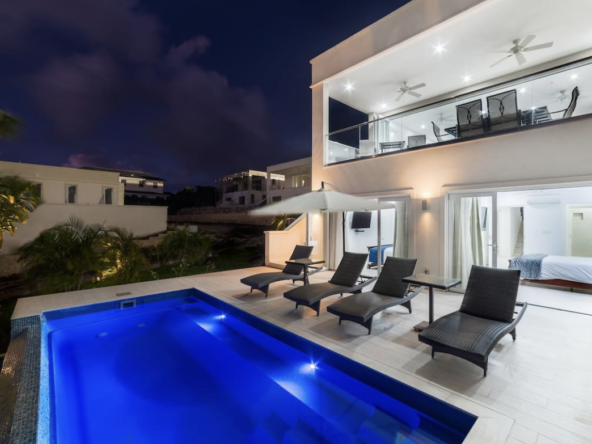 Westmoreland Hills 25 for villa rentals with ocean views - the pool lit at night.