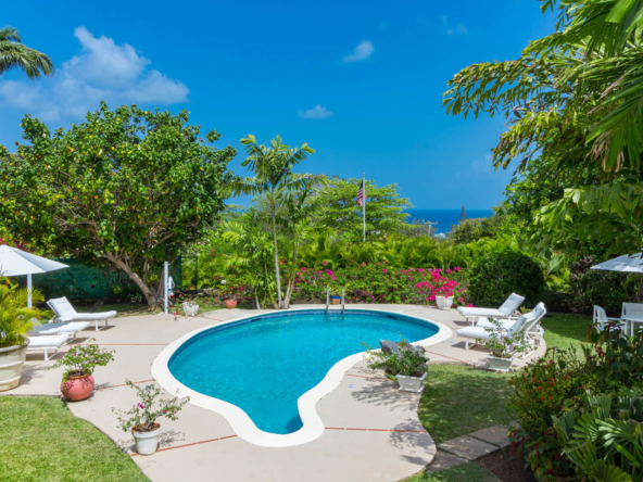 View of pool, garden and blue sky at six bedroom villa Casabella