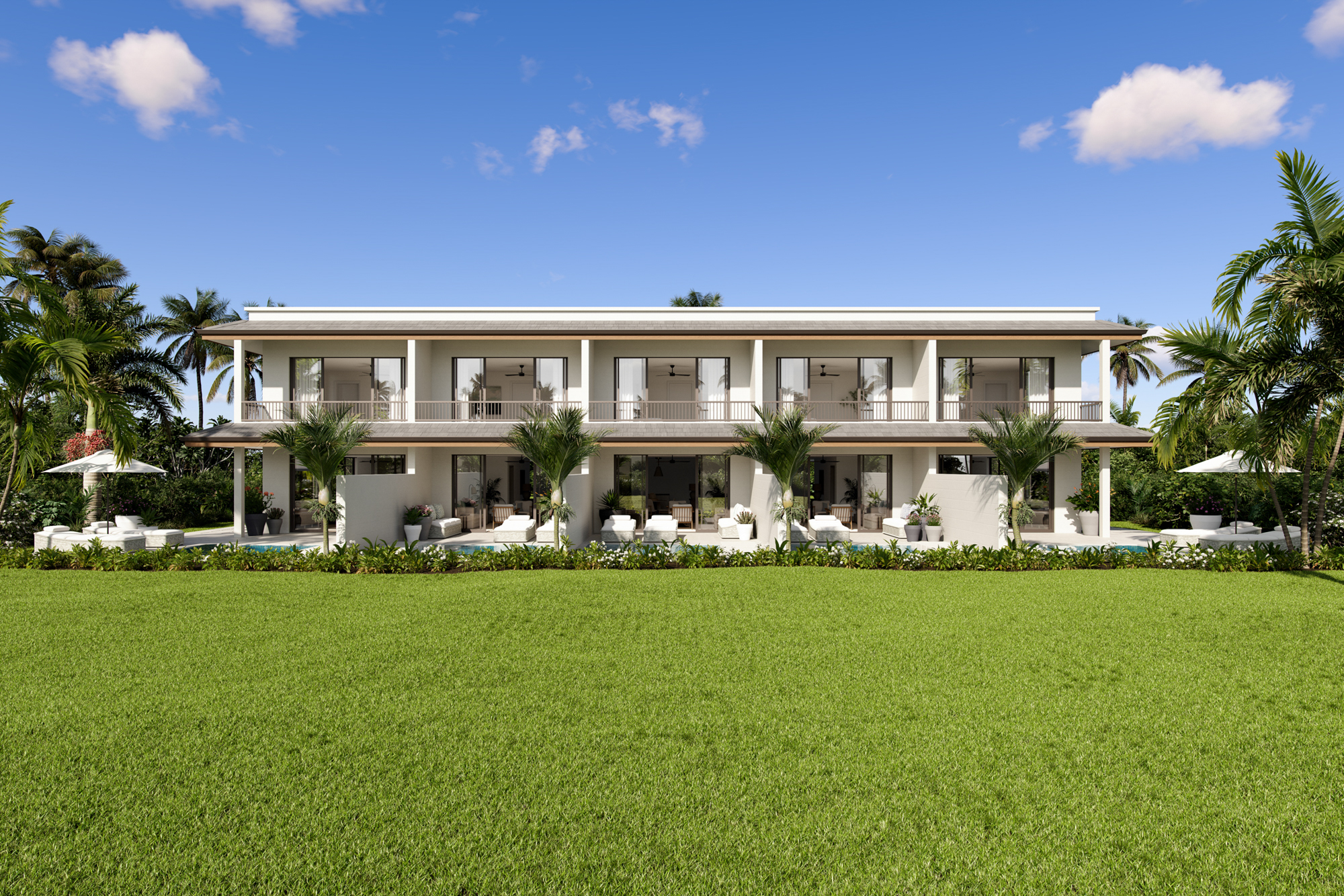 Lancaster Mews exterior with blue sky and green lawn at golf resort Barbados, Royal Westmoreland